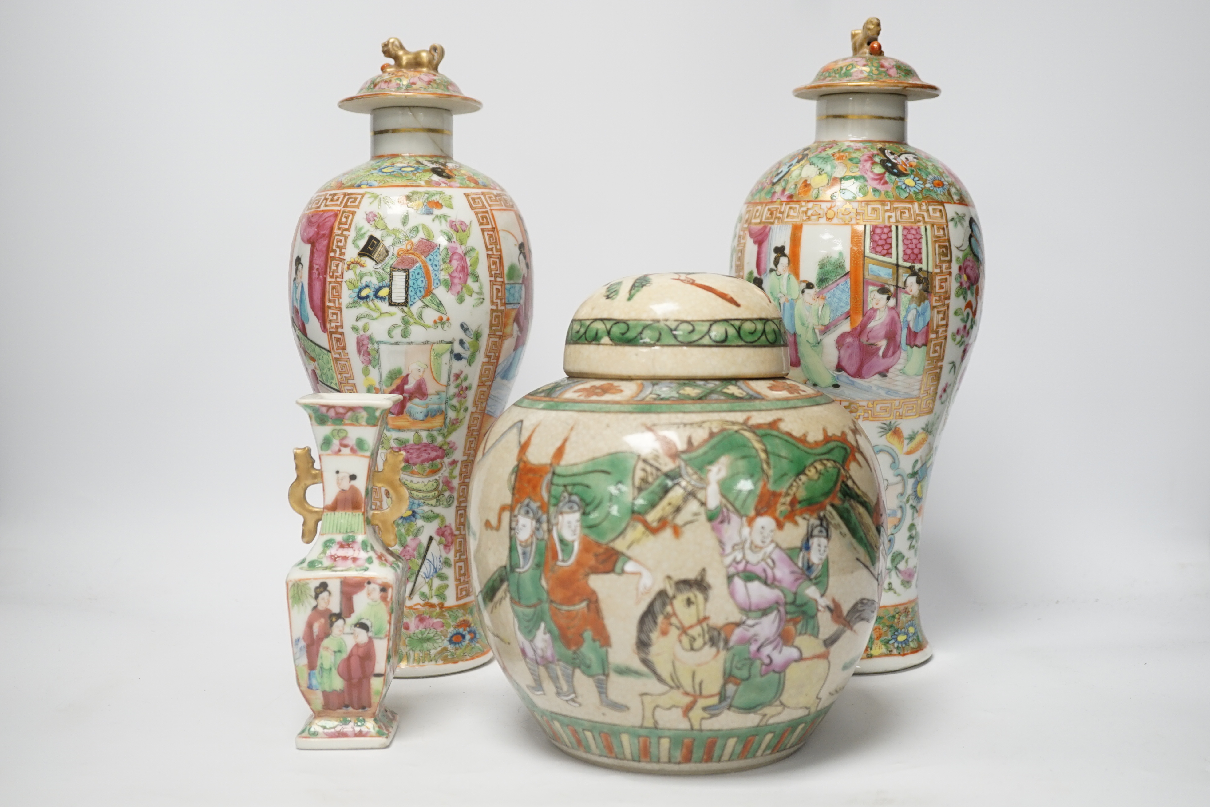 A pair of 19th century Chinese famille rose vases and covers, a similar small vase and a a famille verte crackle glaze jar, tallest 31cm